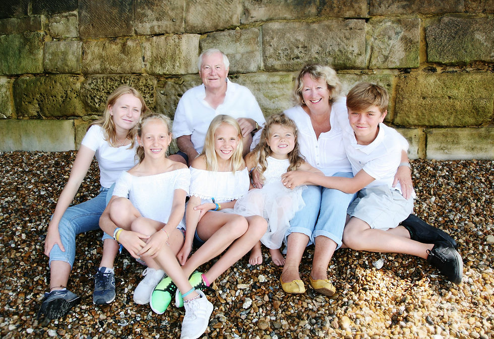 Family photo shoot taken on Southsea beach by seasoned photographer, Naomi Lloyd. Multi-generational family portrait, the perfect gift for grandparents.