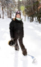 Liz of mountain edge performance smiling while in her snowboard attire on a sunny day