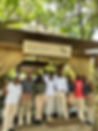 Smiling team members outside a building