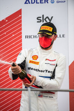 Cooper spraying champagne.