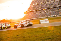 Porsche racing at sunset.