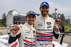 Drivers holding up number 1 signs.