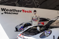 Cooper standing with Porsche.