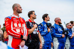 SVG and crew standing on the grid.