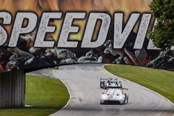 Porsche driving on the track.