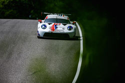 Porsche coming down a hill.