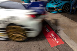 Ferrari peeling out of the pit.
