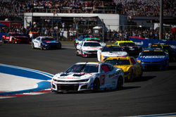 Camaro rounding a turn in traffic.