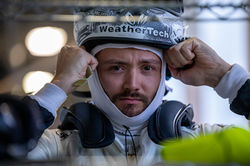 Cooper adjusting the racing helmet.