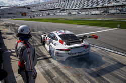 Porsche pulling out of pit road.