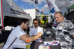 Drivers signing a helmet_