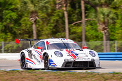 Porsche driving on the track.