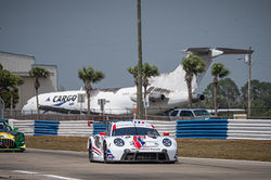 Porsche racing around a turn.