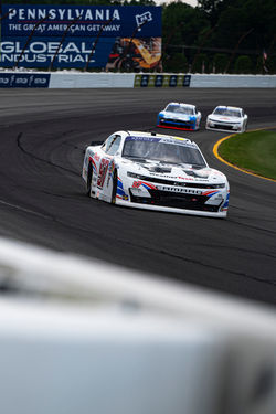 Camaro on the track at the end of a turn.