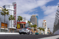 Mercedes with buildings in the background.