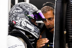 Crew chief talking with Cooper on pit road.