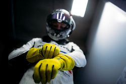 Driver putting gloves on_