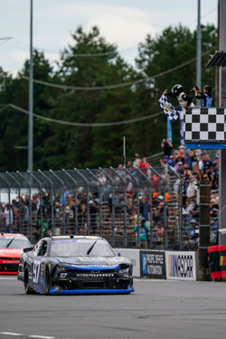 Camaro wide open throttle rolling past the starting line.