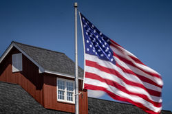 American Flag in front of house.