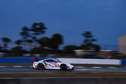 Porsche rounding a turn on the track.