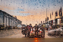 Porsche on pit road in the rain.