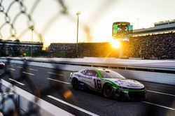 Camaro on straight away with the sun setting in the background.