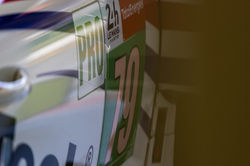 Close up of the Porsche driving down a straight away.