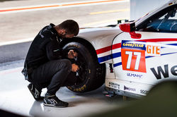 Crew member working on the tires.