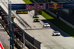 Porsche racing past the starting line.