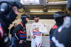 Cooper talking with crew member.