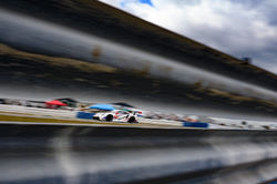 Porsche in traffic on a straight away.