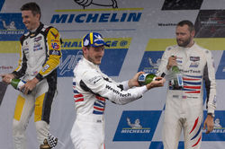 Drivers on podium with Champagne.