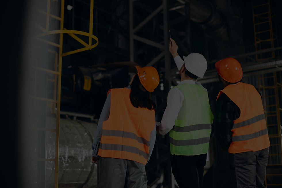 three-factory-workers-safety-hats-discussing-manufacture-plan (2)_edited.jpg