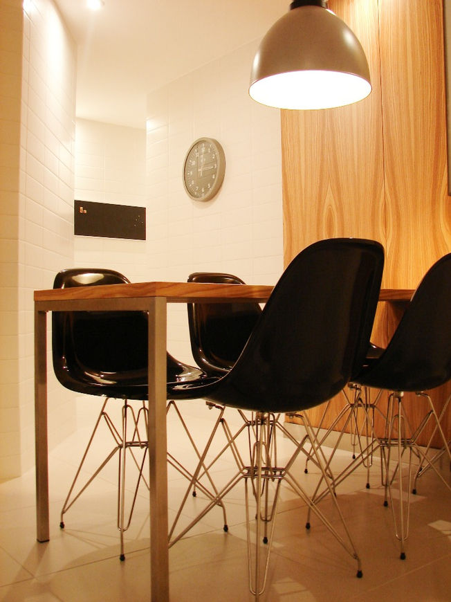 High-end kitchen with with iconic design chairs DKR, timber panels. Cke furniture.lean and bespoke furniture. 