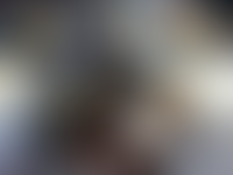 A traditional Kumaoni meal served in stainless steel thalis, including rice, lentils, curry, and vegetable dishes, with sunlight streaming over the table.