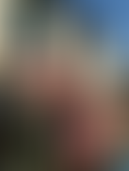 Local women and a child seated on colorful, red-painted steps of a traditional mountain home in a Kumaon village - Binsar, Uttarakhand.