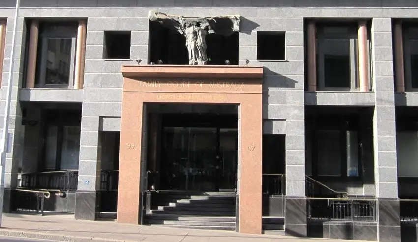 Eye-level view of a courthouse entrance with Australian flags