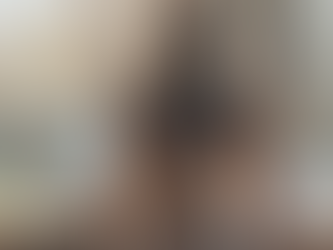 A woman sitting in front of a window in a meditative position with the sun gently hitting her - an example of a reset ritual for busy moms.