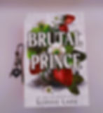 Dark romance book cover for 'Brutal Prince' by Sophie Lark, featuring white and red strawberries.
