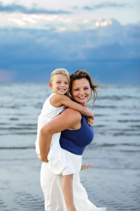 Mom and daughter enjoying a peaceful moment together on the beach, capturing family love in a natural setting. cape cod photographers