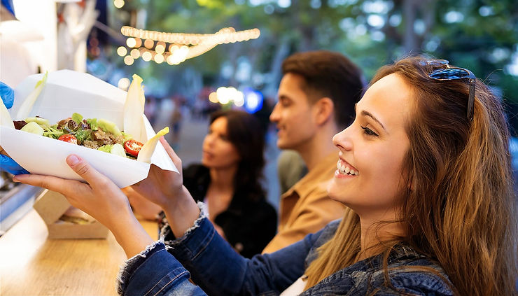Woman receiving food at Hamilton Night Markets