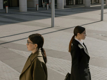 Two professional women collaborating on manage business growth and strategic execution at a desk, representing the female entrepreneur leadership mindset and the support provided by OCW Studio.