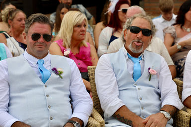 Two men in vests and ties; wedding guests. Darren and Hayley, fun moment captured.