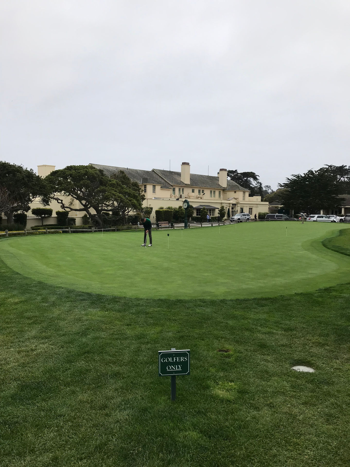 Solo golfer on the practice green at Pebble Beach