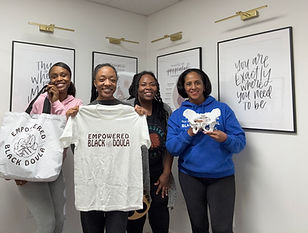 Smiling doula holding certification from Empowered Black Doula