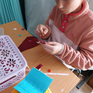 a Young girl busy with a hand sewing workshop