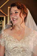 A bride in her tan wedding dress on the last fitting day in a sewing studio