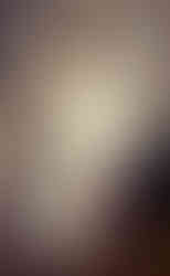 A bride is standing in the wind with her flowy wedding dress during a fitting session