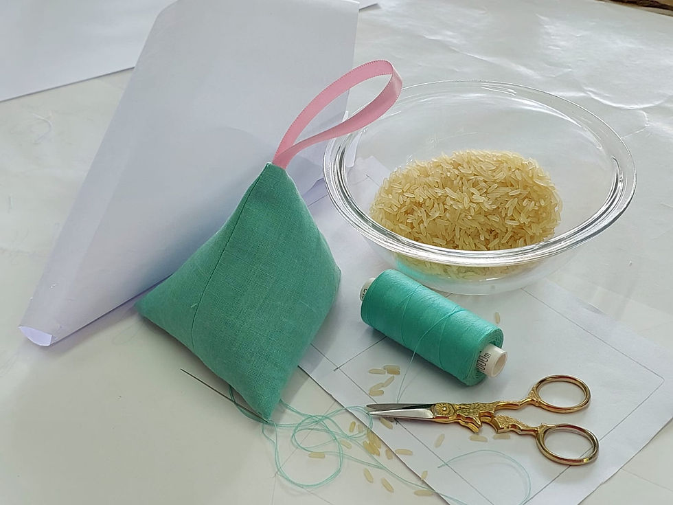 Mint colored paperweight with matching cotton and cotton scissors sitting next to a rice bowl