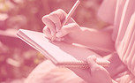 Mãos femininas escrevendo em um caderno